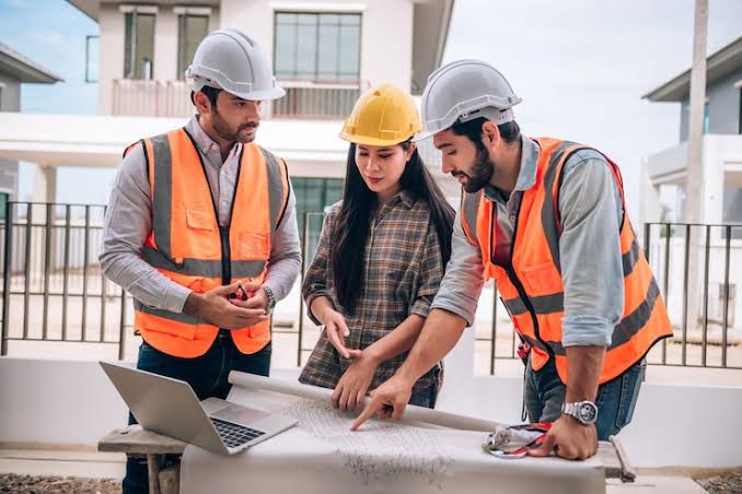 GLS Construction team reviewing building plans on site